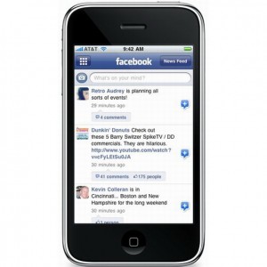 Photo of mobile phone with Facebook statuses on it. 